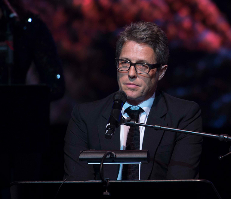 Hugh Grant with a microphone
